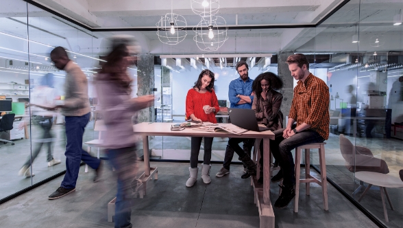 A group of people collaborating around a table in an conference room