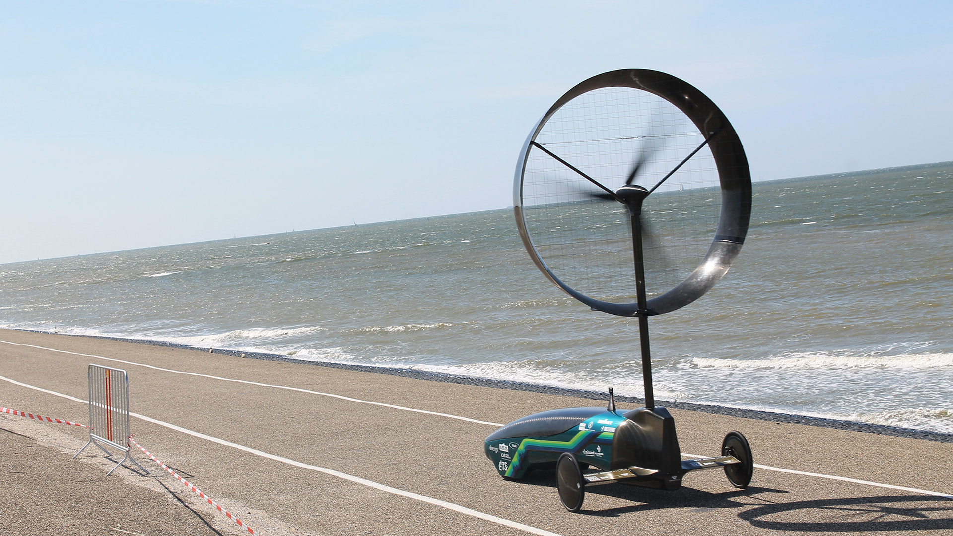 The wind-powered car designed by the Chinook engineering team drives by water