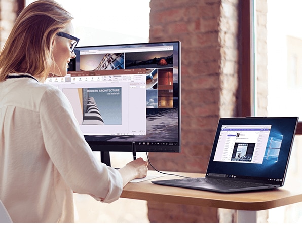 Lenovo Yoga S940 laptop, connected to large monitor in workplace setting